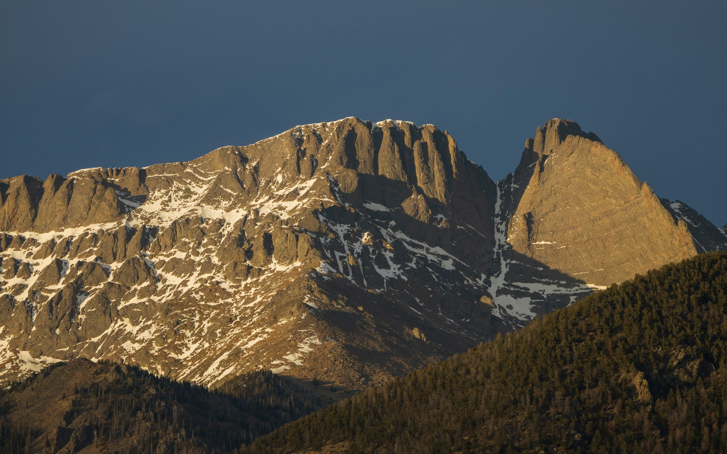 The Crestone peaks under a deep blue evening sky